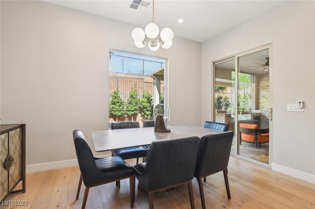 dining space with a chandelier, light wood-style flooring, recessed lighting, visible vents, and baseboards