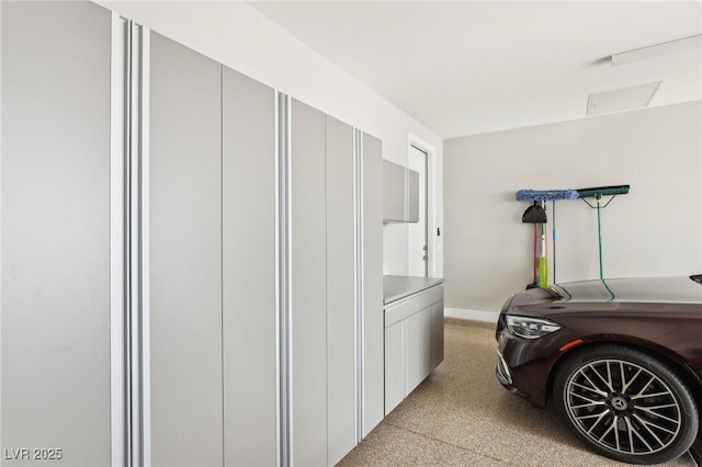 clothes washing area with laundry area and baseboards