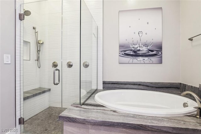 full bath featuring a garden tub and a shower stall