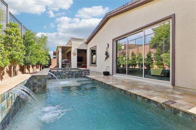 view of swimming pool featuring area for grilling, a patio, a fenced backyard, a grill, and a pool with connected hot tub