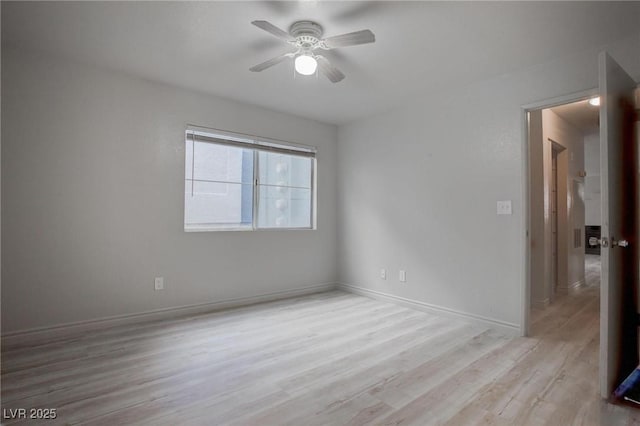 unfurnished room with ceiling fan, baseboards, and wood finished floors