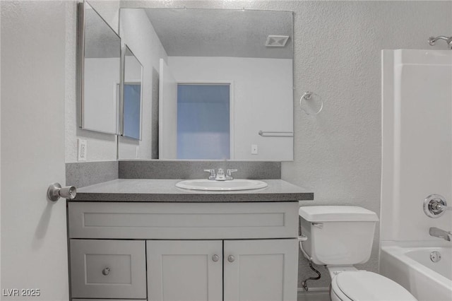 full bathroom with a textured wall, shower / tub combination, toilet, visible vents, and vanity