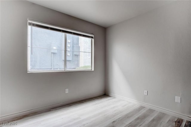 empty room with wood finished floors and baseboards