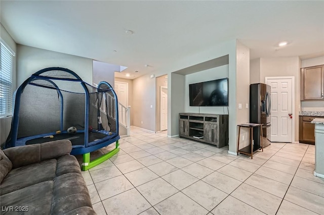 living room with recessed lighting, stairs, baseboards, and light tile patterned flooring