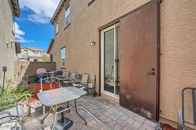 view of patio featuring fence