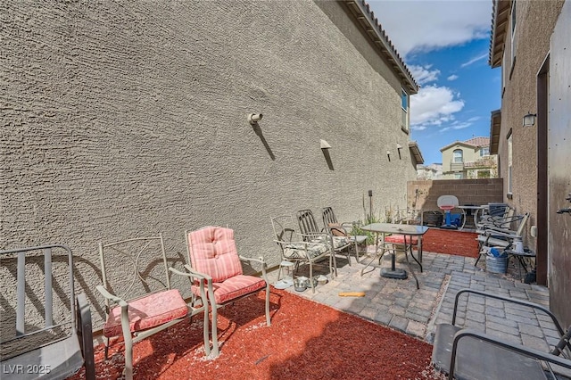 view of patio / terrace featuring fence