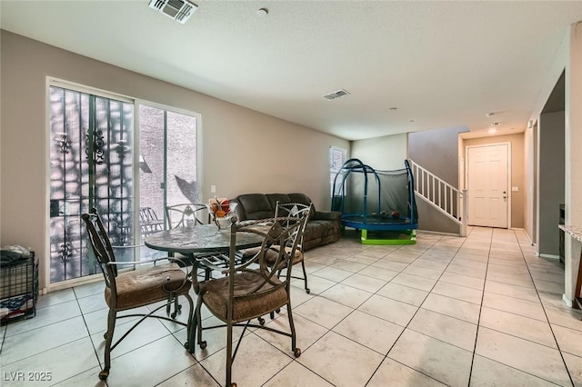 dining area with visible vents, plenty of natural light, and light tile patterned floors