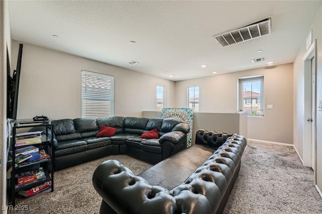 carpeted living room with a textured ceiling, visible vents, and baseboards