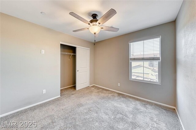 unfurnished bedroom featuring ceiling fan, carpet floors, a closet, and baseboards