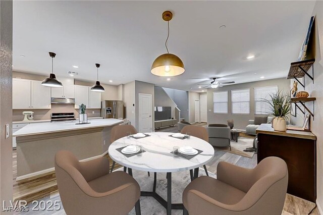 dining space with ceiling fan, light wood-type flooring, visible vents, and recessed lighting