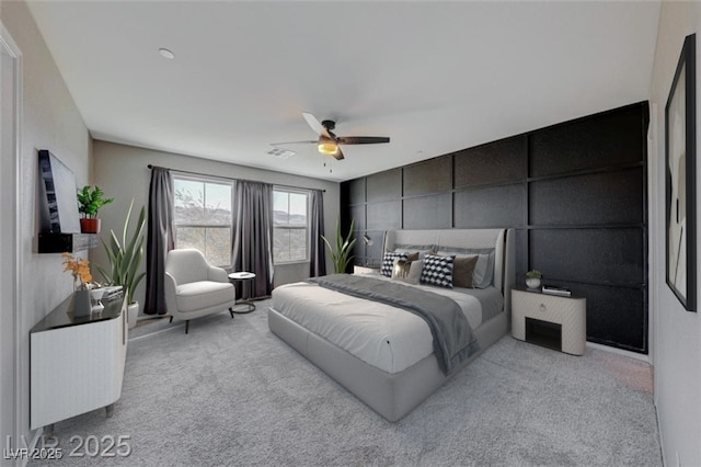 carpeted bedroom featuring ceiling fan and visible vents