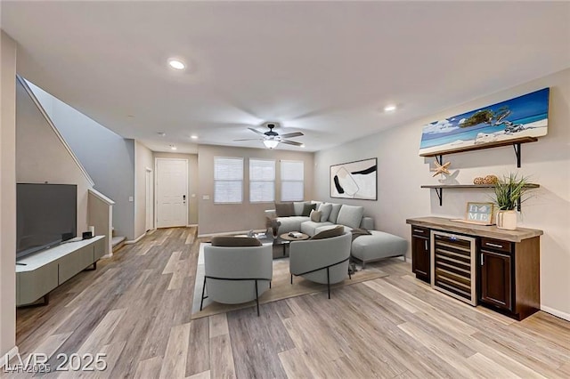 living room with ceiling fan, wine cooler, recessed lighting, baseboards, and light wood-type flooring