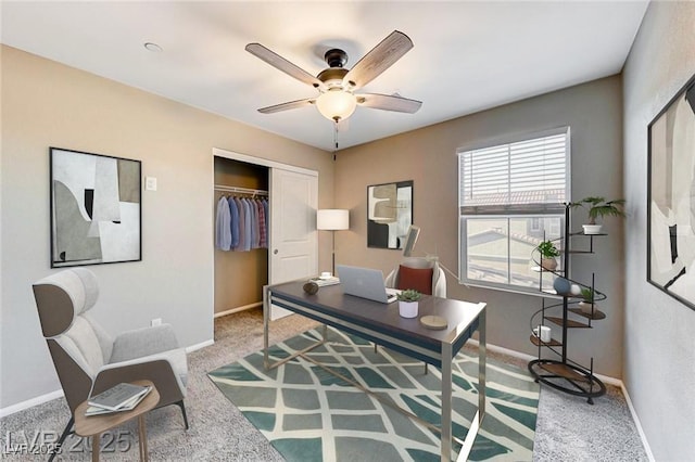 office area with carpet floors, baseboards, and a ceiling fan