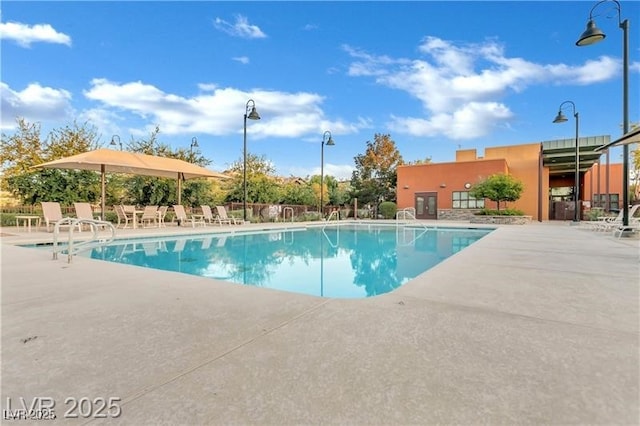 pool with fence and a patio