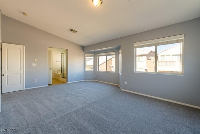 unfurnished bedroom featuring visible vents, lofted ceiling, baseboards, and carpet flooring