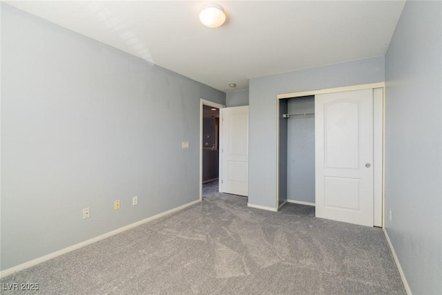 unfurnished bedroom with a closet, baseboards, and carpet flooring