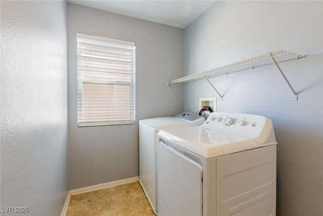 laundry room featuring laundry area, baseboards, and washer and clothes dryer