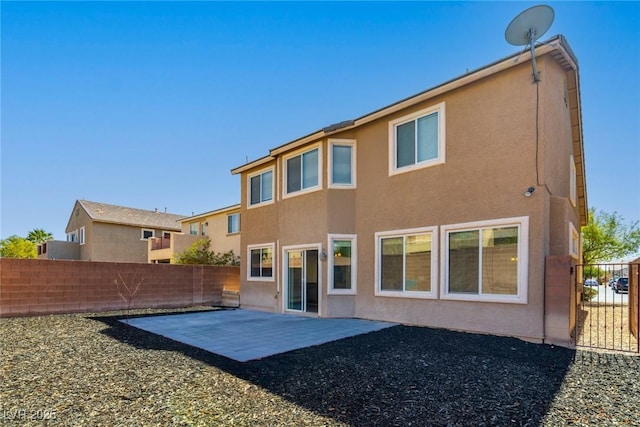 back of house with a patio area, stucco siding, and fence private yard