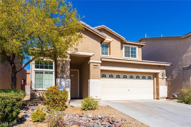 view of front of house with a tiled roof, stucco siding, an attached garage, and concrete driveway