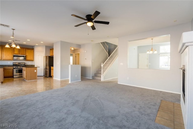 unfurnished living room featuring carpet, visible vents, baseboards, recessed lighting, and stairs