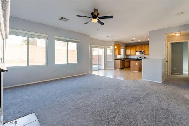 unfurnished living room with recessed lighting, visible vents, light colored carpet, and baseboards