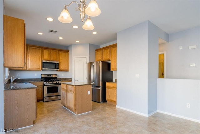 kitchen featuring a sink, dark stone countertops, a kitchen island, recessed lighting, and stainless steel appliances