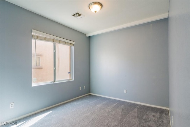 carpeted spare room featuring visible vents, a healthy amount of sunlight, and baseboards