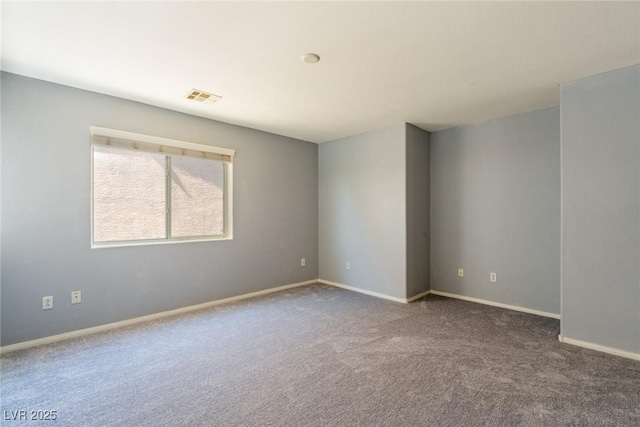 unfurnished room with visible vents, baseboards, and carpet