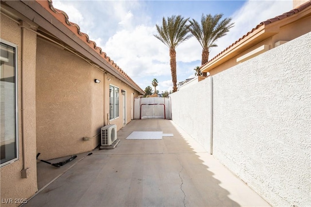 view of patio with ac unit and a fenced backyard