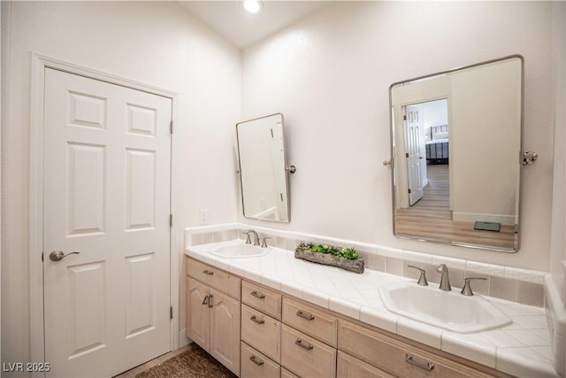 bathroom featuring a sink and double vanity