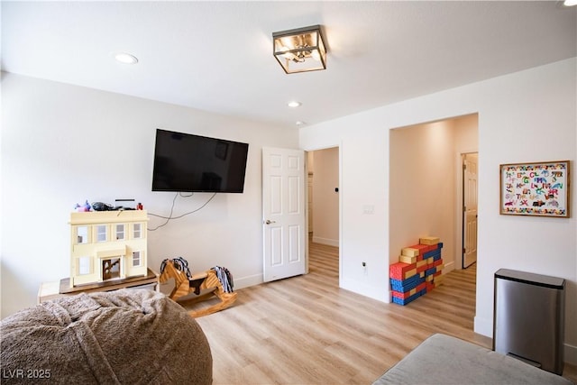 interior space with baseboards, light wood-style flooring, and recessed lighting