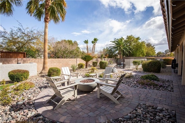 view of patio / terrace featuring a fenced backyard and a fire pit