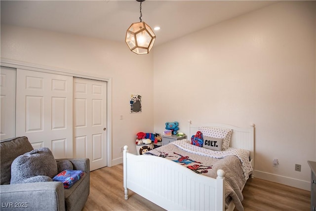 bedroom featuring recessed lighting, a closet, light wood-type flooring, and baseboards