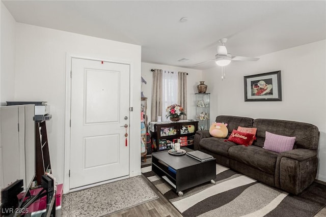 living room featuring a ceiling fan and wood finished floors