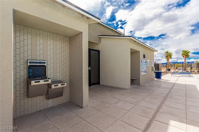 view of patio with fence, cooling unit, and heating unit