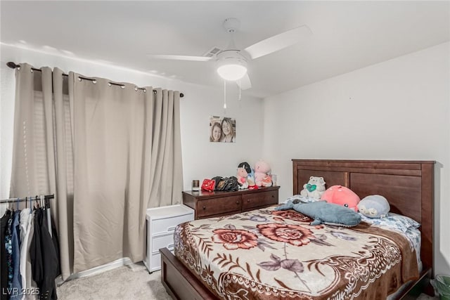 bedroom with light carpet and a ceiling fan