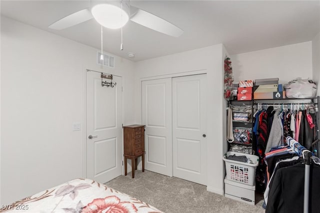 bedroom with a ceiling fan, carpet, a closet, and visible vents