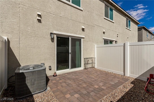 view of patio with fence and central air condition unit