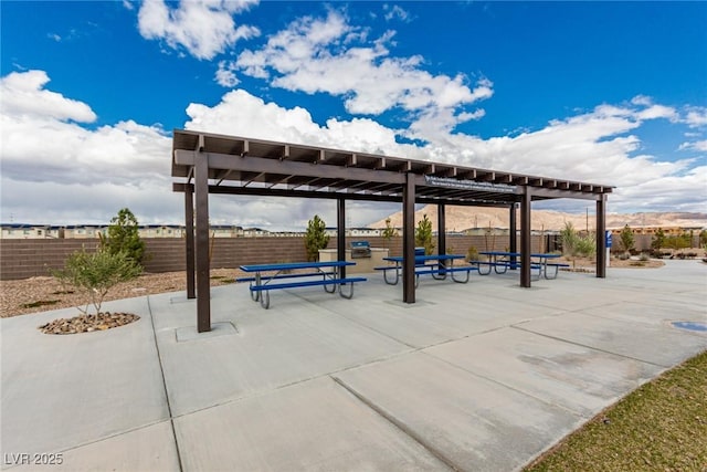 view of community with fence and a pergola