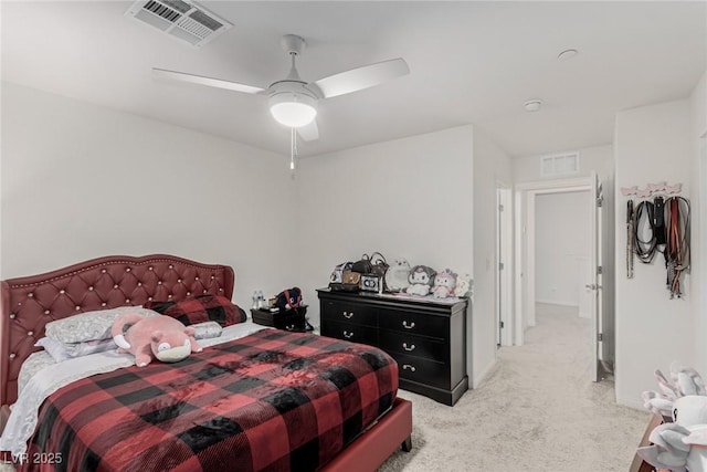 bedroom with light carpet, ceiling fan, visible vents, and baseboards