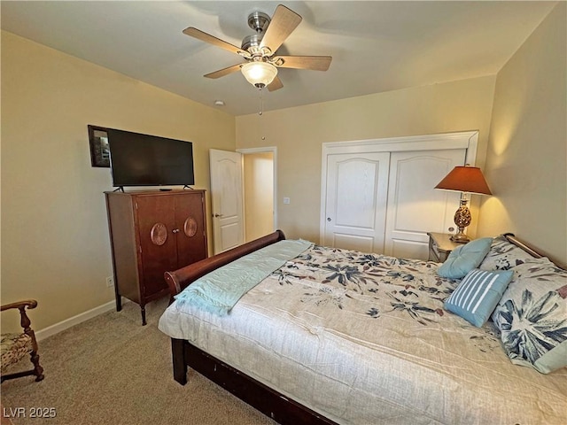 carpeted bedroom with a ceiling fan, a closet, and baseboards