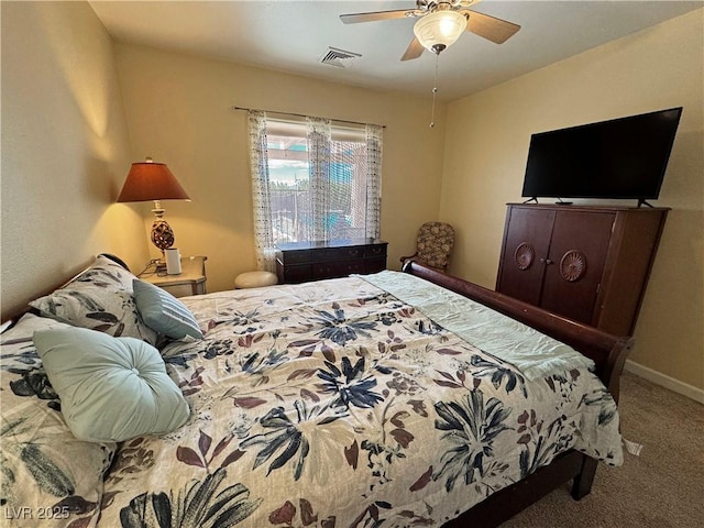 carpeted bedroom with baseboards, visible vents, and ceiling fan