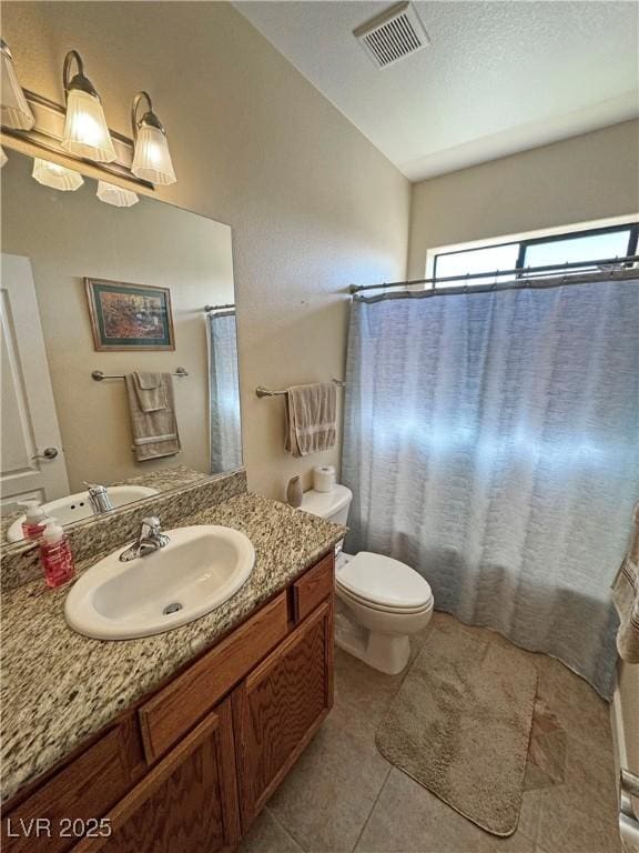 bathroom with visible vents, toilet, tile patterned floors, shower / bath combo with shower curtain, and vanity