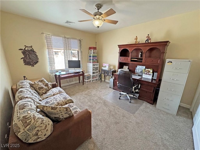 carpeted home office with baseboards, visible vents, and a ceiling fan