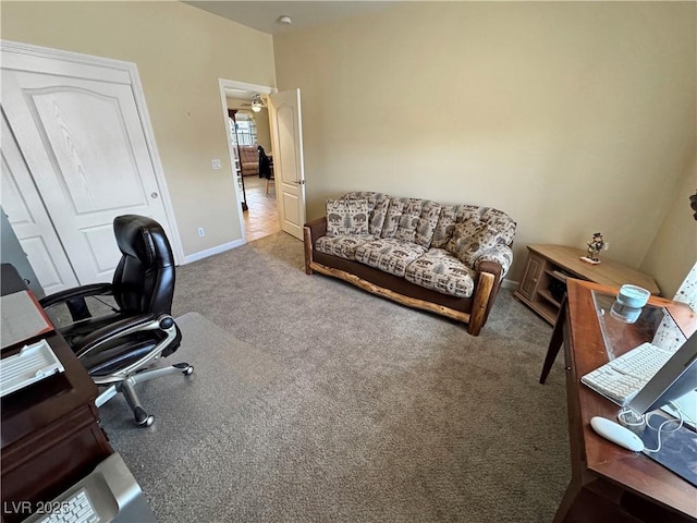 carpeted office featuring baseboards