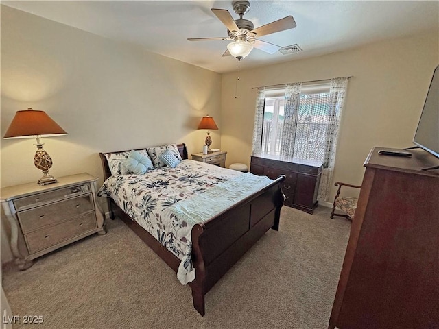 bedroom featuring baseboards, a ceiling fan, visible vents, and light colored carpet