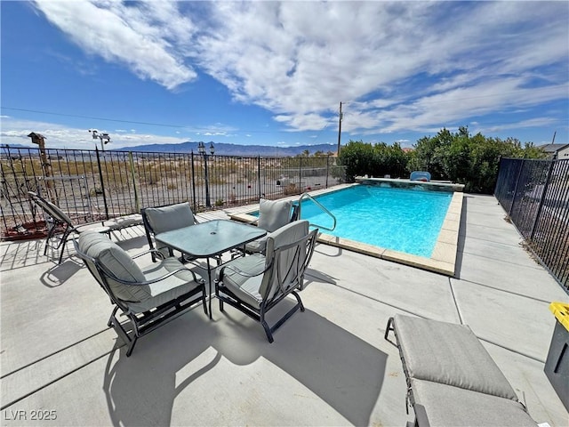 view of swimming pool with a fenced in pool, a patio area, a fenced backyard, and a mountain view