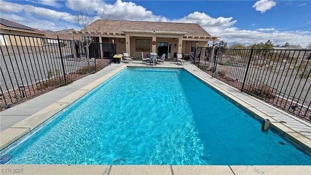 view of swimming pool featuring a fenced in pool, a patio area, and fence