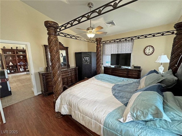 bedroom with lofted ceiling, visible vents, ceiling fan, wood finished floors, and baseboards