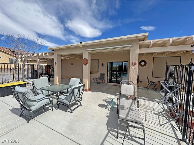 view of patio / terrace featuring outdoor dining space, fence, and a pergola